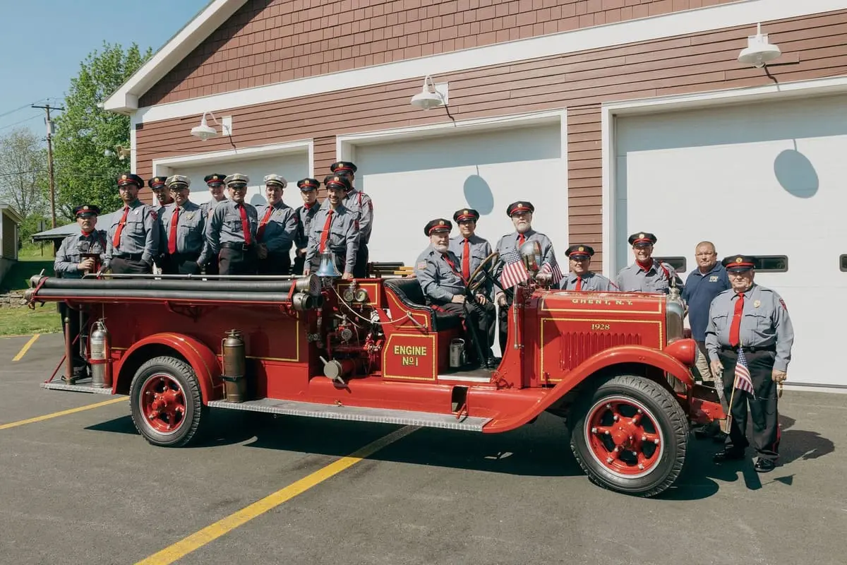 Engine No. 1 Outside Station 1 — Our 1928 American LaFrance staged in front of the modern Route 66 firehouse bays.