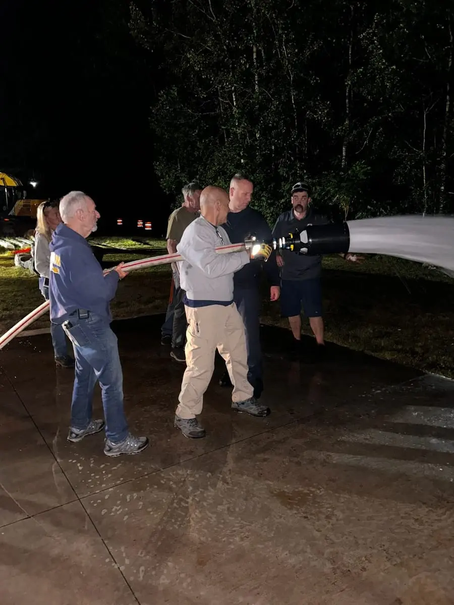 Class B Foam Blanket Drill — Deploying compressed-air and educted fire suppression foam during an evening drill.