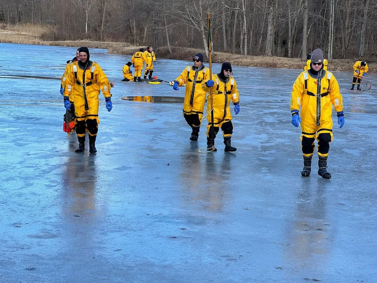 Ghent volunteers in Mustang cold-water survival suits practicing ice rescue on a frozen local pond