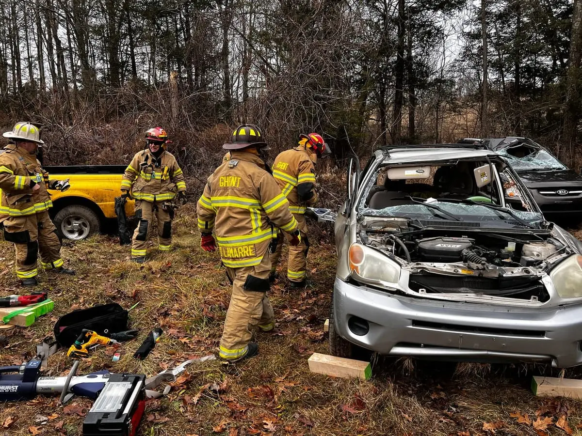 Ghent firefighters operating hydraulic Jaws of Life rescue tools during an auto extrication drill
