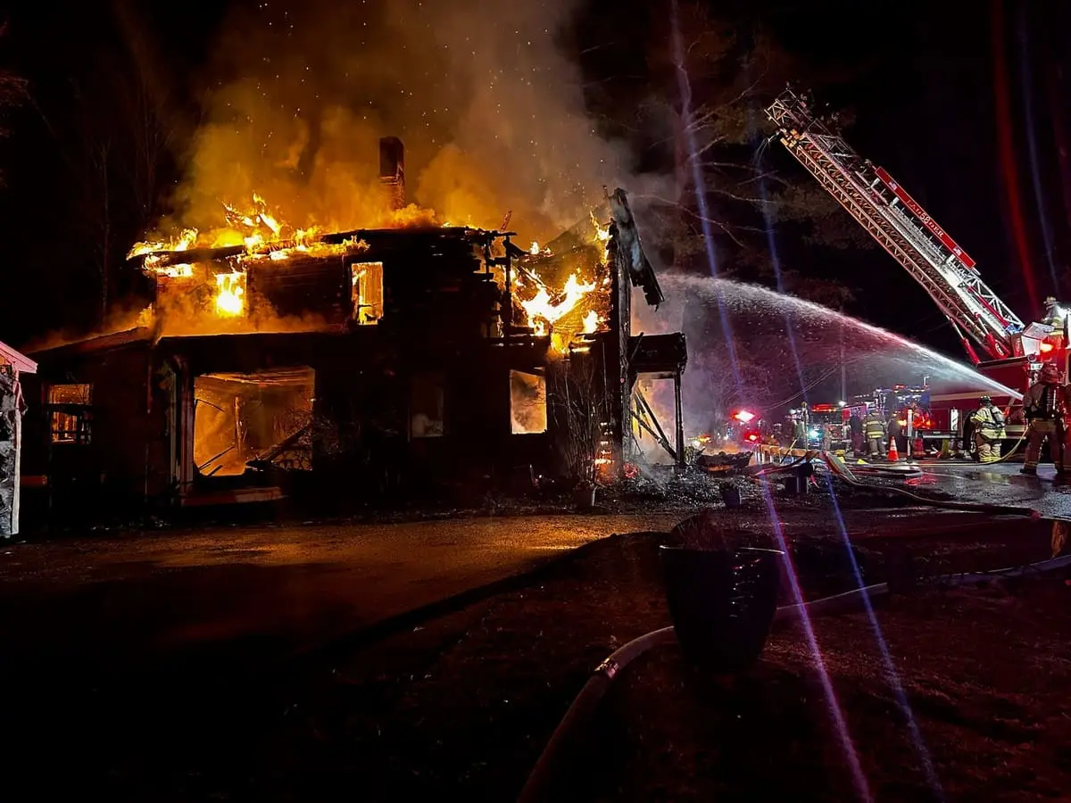 Ghent Volunteer Fire Company firefighters operating attack hoselines at a nighttime structure fire